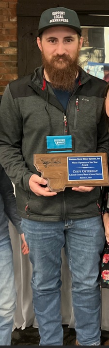 Proud man standing with award