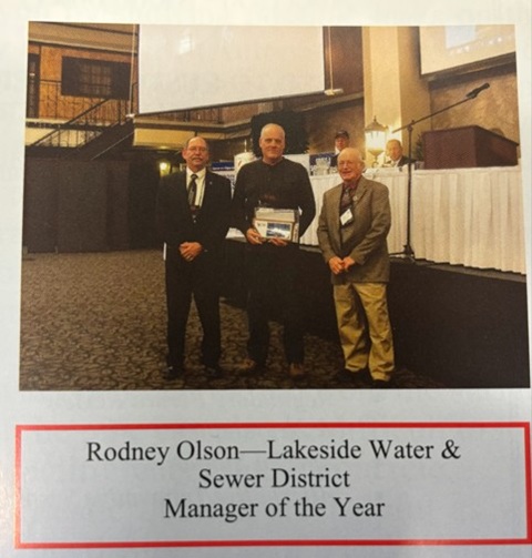 Three men at award presentation